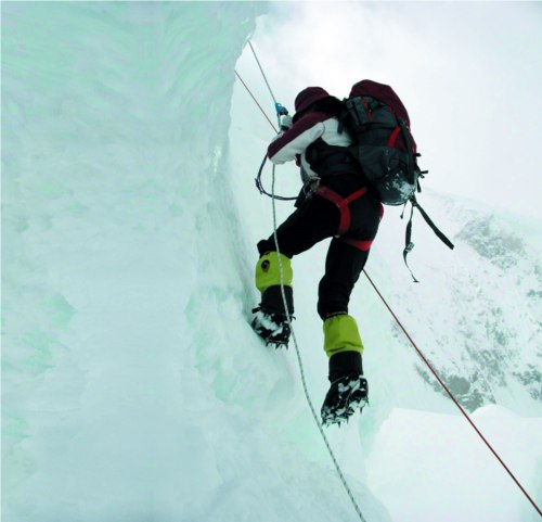 Jiji is climbing the ice-covered cliff.